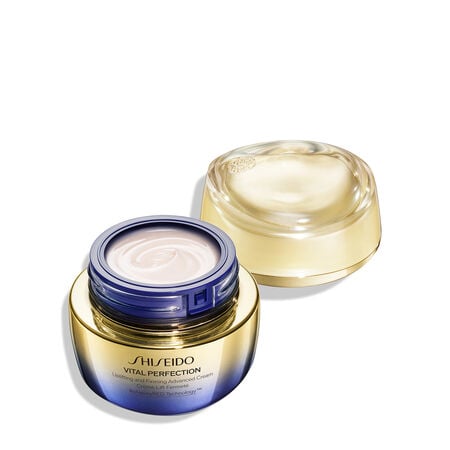 Un frasco redondo de color dorado y morado de la crema Shiseido Vital Perfection Uplifting and Firming Advanced Cream. El frasco cerrado lleva el logotipo de Shiseido, el nombre del producto y las palabras "ReNeuraRED Technology".